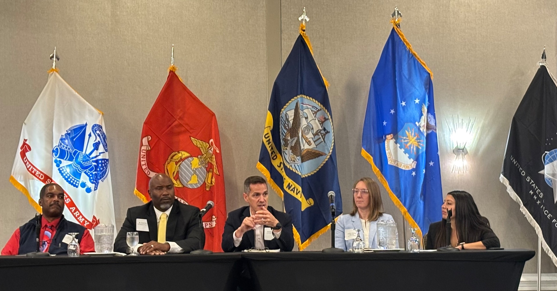 Panel sitting behind tables.