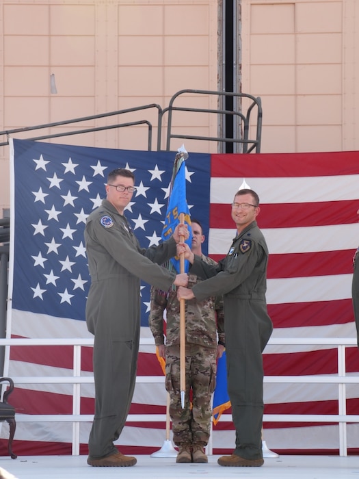 Lt. Col. Samuel Wright III, right, takes the guidon from then-704th Test Group commander and current Arnold Engineering Development Complex Commander Col. Wayne Dirkes to assume command of the 586th Flight Test Squadron during a June 9, 2026, Change of Command ceremony at Holloman Air Force Base, N.M. Wright brings to his latest assignment more than 2,800 military flight hours as a development test pilot and evaluator pilot in more than 30 aircraft types. (U.S. Air Force photo)