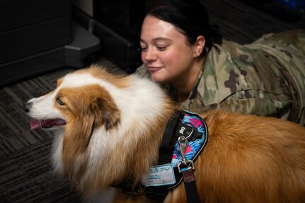 Pennsylvania Air National Guardsman Master Sgt. Jillian Dietrick, assigned to the Force Support, 171st Air Refueling Wing, Pennsylvania Air National Guard, visits with Ashoka, a certified therapy dog, July 8, 2026. Ashoka's visit helped boost morale and reduce stress among the Guardsmen who are responsible for maintaining the wings mission readiness. (U.S. Air National Guard photo by Tech. Sgt. Rebecca A. Wirth)