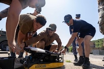 U.S. Sailors assigned to Explosive Ordnance Disposal Mobile Unit 8 explore the VideoRay Defender-Viper mine disposal system with members of the Royal Navy Diving and Threat Exploitative Group Delta Squadron and other Allied nations during an explosive ordnance disposal training on remote operated vehicles at Sea Breeze 2026 in Portland, England, July 14, 2026. Sea Breeze is an annual maritime exercise aimed at building collective capability and agility to restore security and stability in the dynamic Black Sea. Sea Breeze 2026-2 is focused on mine countermeasure, explosive ordnance disposal, dive operations and unmanned underwater vehicles. (U.S. Navy photo by Mass Communication Specialist 2nd Class Leon Vonguyen)