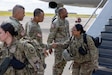 Col. Aaron Jones, commander of the 505th Theater Tactical Signal Brigade, greets a Soldier assigned to the 319th Expeditionary Signal Battalion following the unit's return from an overseas deployment at an undisclosed location in the United States, June 1, 2026. Also pictured is U.S. Army Reserve Brig. Gen. Tonri Brown, deputy commanding general – signal, 335th Signal Command (Theater). Senior leaders welcomed home the Soldiers and thanked them for their dedication, service and commitment to the mission. (U.S. Army Reserve photo by Sgt. Seth Smith)