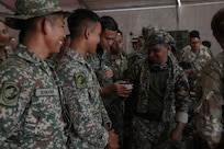 Malaysian Army soldiers from Bravo Company, 1st Medical Battalion, check a correctly filled blood bag during a mobile blood bank training workshop.
