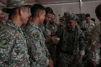 Malaysian Army soldiers from Bravo Company, 1st Medical Battalion, check a correctly filled blood bag during a mobile blood bank training workshop.