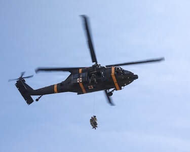 A UH-60 Black Hawk helicopter hoists a simulated casualty during a joint medical evacuation training event between the 709th Medical Company (Area Support), Illinois Army National Guard, and the Malaysian Army's 5th Infantry Division.