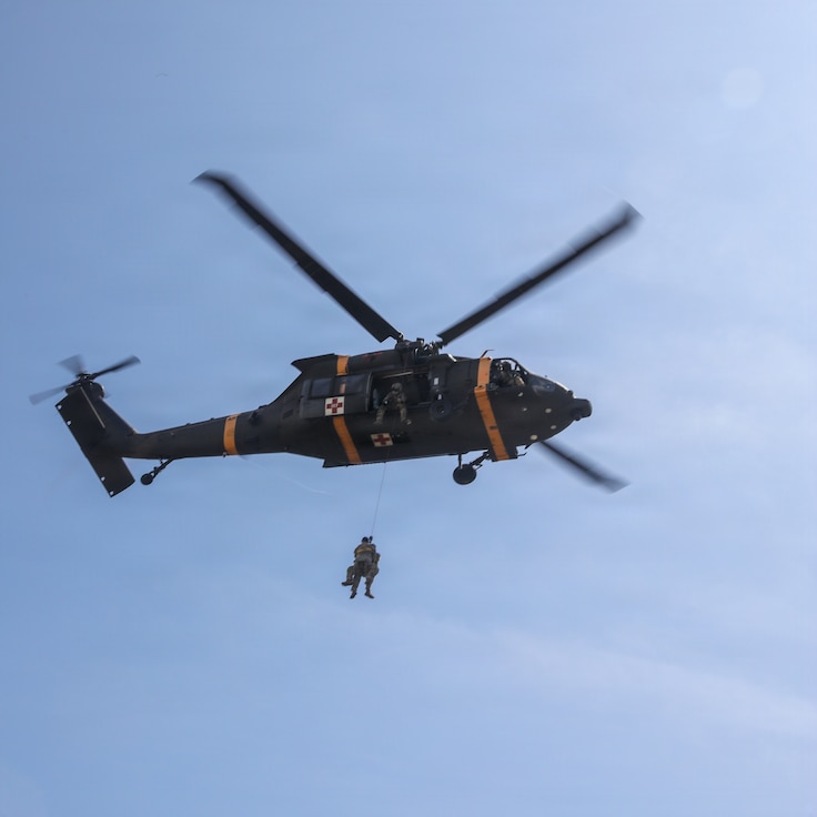 A UH-60 Black Hawk helicopter hoists a simulated casualty during a joint medical evacuation training event between the 709th Medical Company (Area Support), Illinois Army National Guard, and the Malaysian Army's 5th Infantry Division.