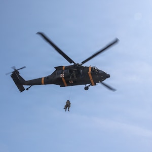 A UH-60 Black Hawk helicopter hoists a simulated casualty during a joint medical evacuation training event between the 709th Medical Company (Area Support), Illinois Army National Guard, and the Malaysian Army's 5th Infantry Division.