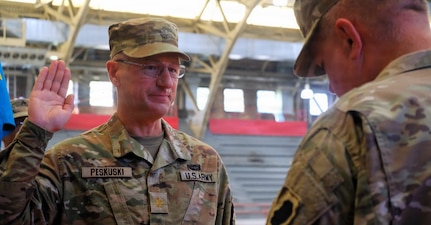 Maj. A.J. Peskuski, Commander of the 139th Mobile Public Affairs Detachment, recites the oath of office during his promotion ceremony at General Jones Armory in Chicago.