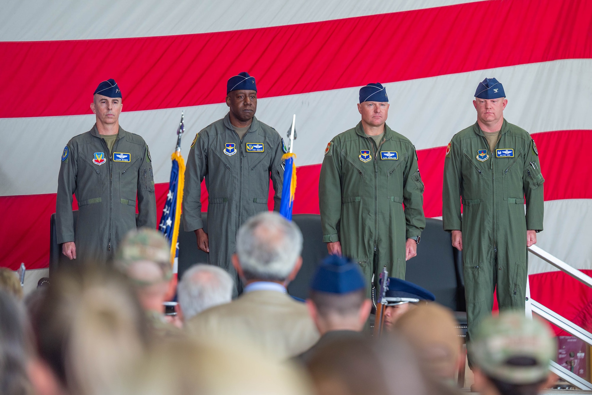 From left, U.S. Air Force Maj. Gen. Steven Behmer, 15th Air Force commander, Brig. Gen. Travolis Simmons, 19th Air Force commander, Brig. Gen. David Berkland, outgoing 56th Fighter Wing commander, and Col. Nicholas Ihde, incoming 56th Fighter Wing commander, stand at attention during the 56th Fighter Wing change of command and major command reassignment ceremony at Luke Air Force Base, Arizona, July 17, 2026.