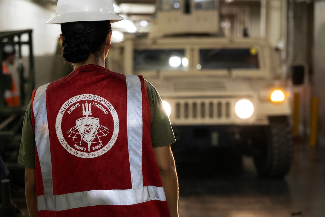 U.S. Marine Corps Sgt. Mariah Aparicio, an embarker assigned to Blount Island Command's technical assistance and advisory team, oversees vehicle movement during offload preparations July 14, 2026, aboard USNS Sisler near Pohang, South Korea. Blount Island Command personnel supported embarkation, equipment accountability and maritime sustainment during Combined Joint Logistics Over-the-Shore 26, which integrated U.S. and Republic of Korea lighterage and ship-to-shore connector capabilities. (U.S. Marine Corps photo by Dustin Senger)