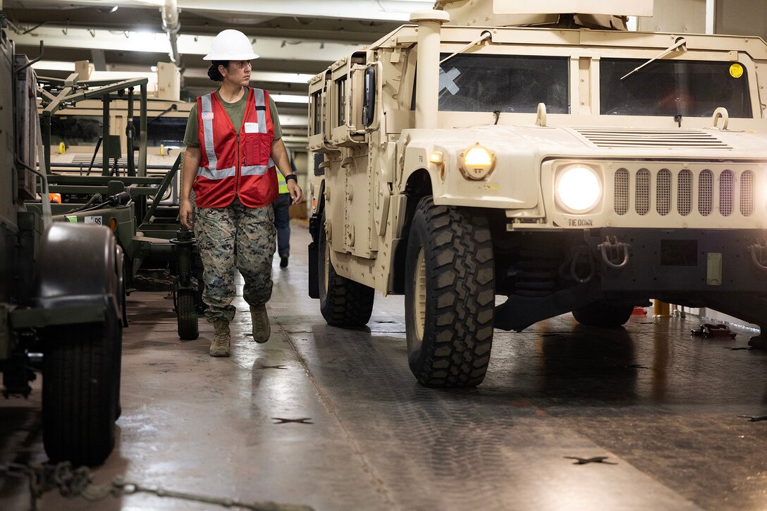 U.S. Marine Corps Sgt. Mariah Aparicio, an embarker assigned to Blount Island Command's technical assistance and advisory team, oversees vehicle movement during offload preparations July 14, 2026, aboard USNS Sisler near Pohang, South Korea. Blount Island Command personnel supported embarkation, equipment accountability and maritime sustainment during Combined Joint Logistics Over-the-Shore 26, which integrated U.S. and Republic of Korea lighterage and ship-to-shore connector capabilities. (U.S. Marine Corps photo by Dustin Senger)