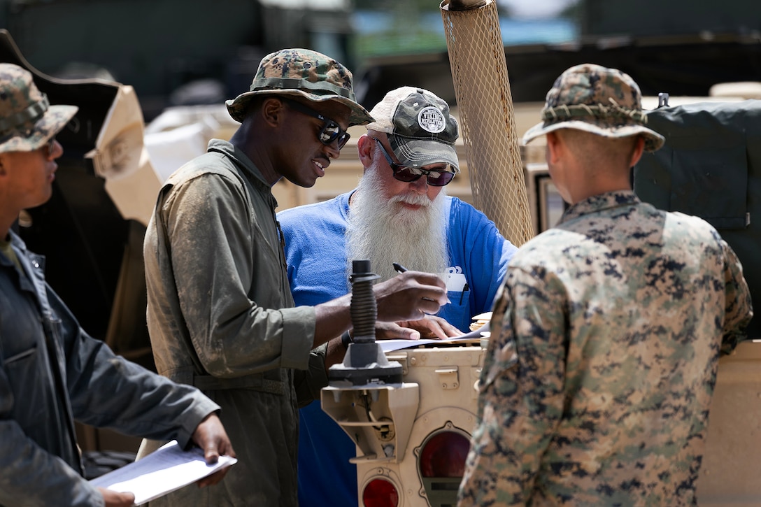 U.S. Marines from 3rd Maintenance Battalion, Combat Logistics Regiment 35, 3rd Marine Logistics Group, review equipment documentation with a maintenance contractor assigned to Blount Island Command's technical assistance and advisory team during joint limited technical inspections July 14, 2026, at a staging area in Pohang, South Korea. Blount Island Command personnel and maintenance contractors provided technical expertise supporting equipment accountability and maritime sustainment during Combined Joint Logistics Over-the-Shore 26. (U.S. Marine Corps photo by Dustin Senger)