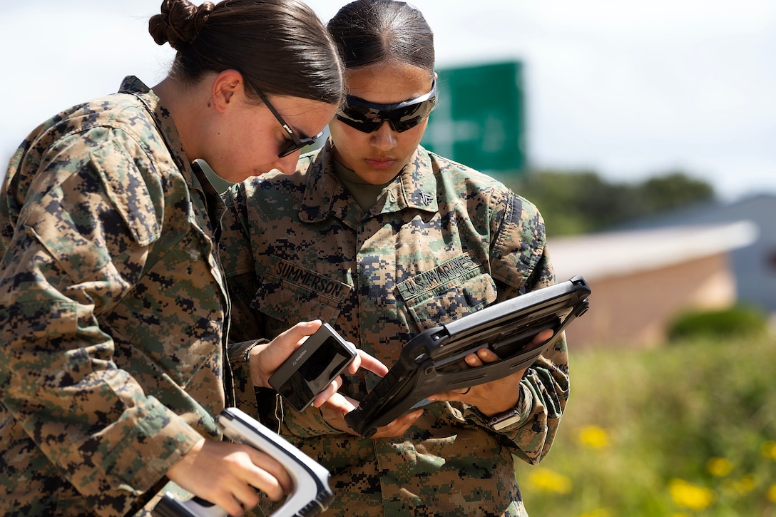 U.S. Marine Corps Sgt. Abigail Raines, a data systems administrator who specializes in the Marine Corps Platform Integration Center for Blount Island Command's technical assistance and advisory team, instructs Cpl. Perla Summerson, assigned to Combat Logistics Regiment 35, 3rd Marine Logistics Group, on handheld radio frequency identification equipment during arrival and assembly operations July 14, 2026, at a staging area near Pohang, South Korea. Blount Island Command personnel provided technical expertise supporting equipment accountability and maritime sustainment during Combined Joint Logistics Over-the-Shore 26. (U.S. Marine Corps photo by Dustin Senger)