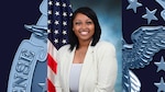 A woman poses in front of the American flag.