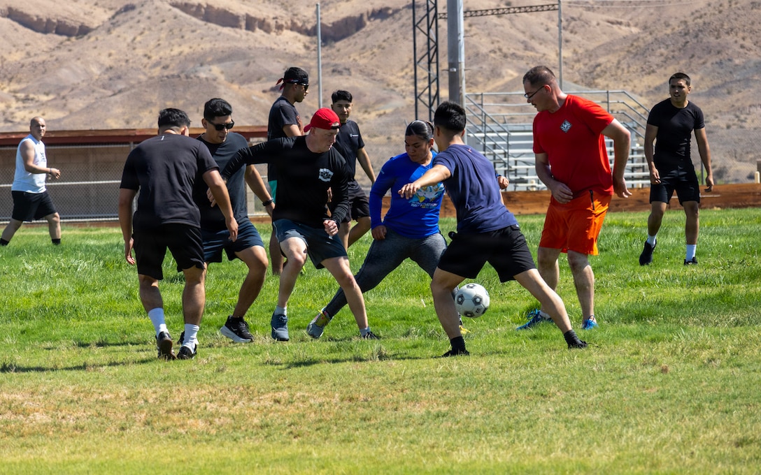 MARINE CORPS LOGISTICS BASE BARSTOW, Calif. — U.S. Marines with Headquarters Company compete in a game of Gator Ball during a company physical training event at Sorenson Field aboard Marine Corps Logistics Base Barstow, California, July 21. The event was held to foster unit cohesion, build camaraderie, and maintain physical fitness and combat readiness across the company staff. (U.S. Marine Corps photo by Kristyn Galvan, COMMSTRAT)