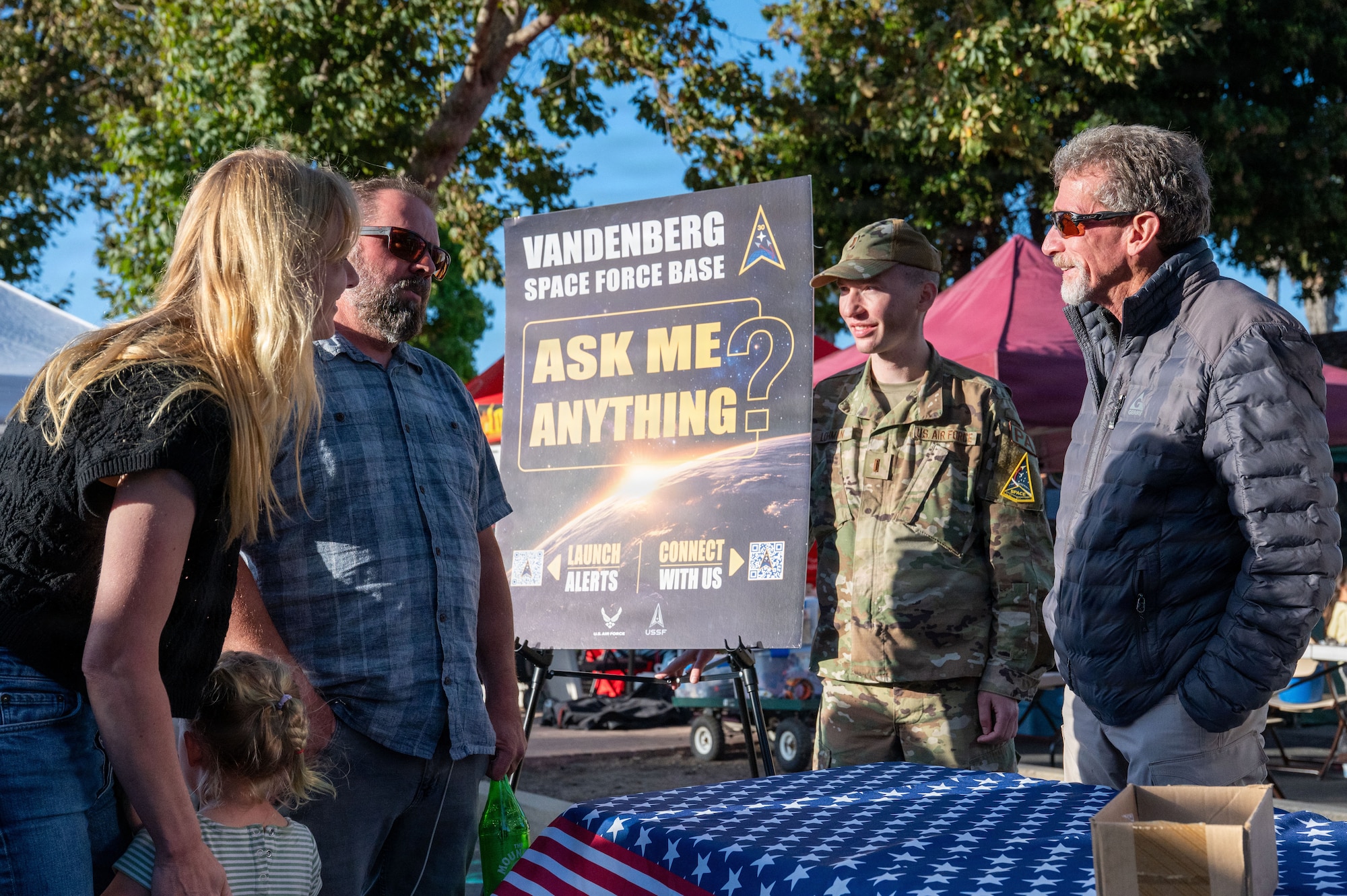 a group of people speak to each other