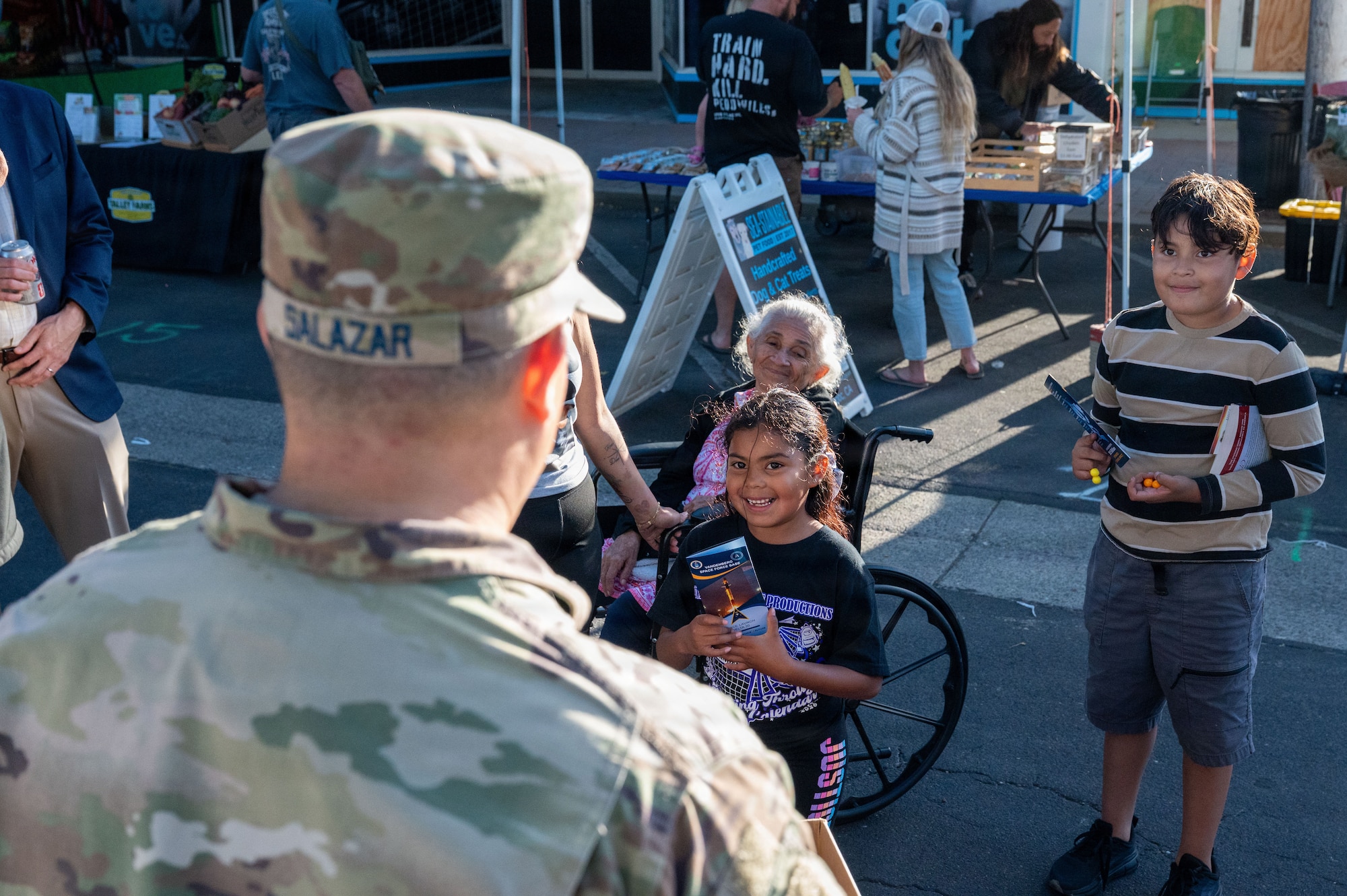 a person speaks to two children