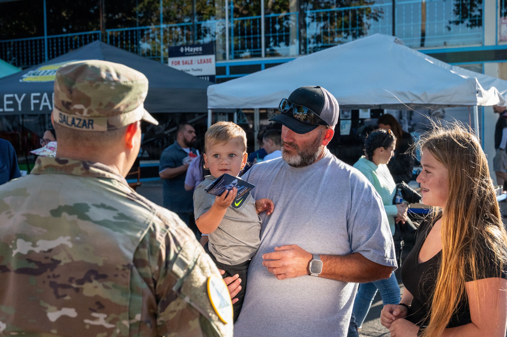 a person speaks to a parent and children