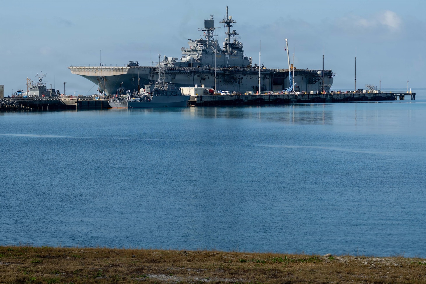 America-class amphibious assault ship USS Tripoli (LHA 7) and embarked 31st Marine Expeditionary Unit arrive at White Beach Naval Facility, Okinawa, Japan, after concluding a dynamic six-month deployment to the U.S. 5th and 7th Fleet areas of operation, July 22, 2026. Tripoli is forward deployed to Sasebo, Japan, and the flagship of Expeditionary Strike Group (ESG) 7 / Commander, Task Force (CTF) 76. Within the U.S. 7th Fleet area of operations, ESG7 / CTF-76 is responsible for conducting expeditionary warfare operations with Navy and Marine Corps capabilities to support theater contingencies that range from crisis response to full combat operations. U.S. 7th Fleet, the Navy’s largest forward-deployed numbered fleet, routinely interacts and operates with allies and partners in preserving a free and open Indo-Pacific. (U.S. Navy photo by Mass Communication Specialist 2nd Class Danilo Reynoso)