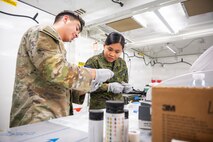 U.S. Army Sgt. Alex Peña, assigned to 62nd Medical Brigade, trains Philippine Army Pfc. Emberlyn Mendoza on a man-portable diagnostic system during Exercise Balikatan 2026 at Fort Magsaysay, Philippines, April 30, 2026.