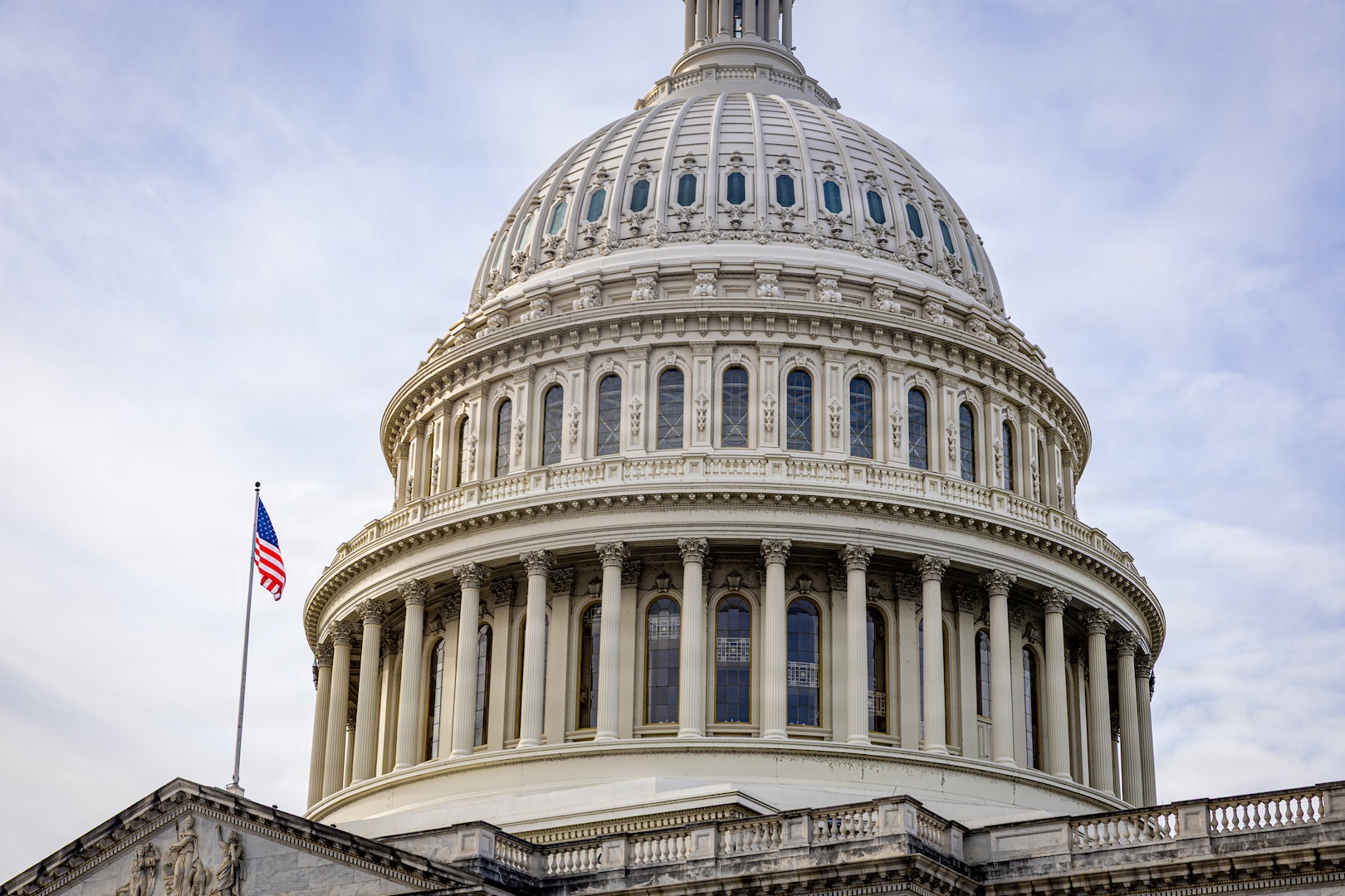A large, dome-shaped building with an American flag flying from the rooftop.