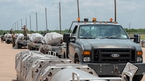 U.S. Air Force Joint Air-to-Surface Standoff Missiles sit staged on munitions trailers during the Death Strike: Trident Fury exercise at Dyess Air Force Base, Texas, June 22, 2026. Death Strike: Trident Fury is a multi-day munitions production exercise focused on strengthening joint interoperability and proving the joint force's ability to rapidly scale operations in a simulated combat environment. (U.S. Air Force photo by Airman 1st Class William Neal)