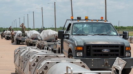 U.S. Air Force Joint Air-to-Surface Standoff Missiles sit staged on munitions trailers during the Death Strike: Trident Fury exercise at Dyess Air Force Base, Texas, June 22, 2026. Death Strike: Trident Fury is a multi-day munitions production exercise focused on strengthening joint interoperability and proving the joint force's ability to rapidly scale operations in a simulated combat environment. (U.S. Air Force photo by Airman 1st Class William Neal)