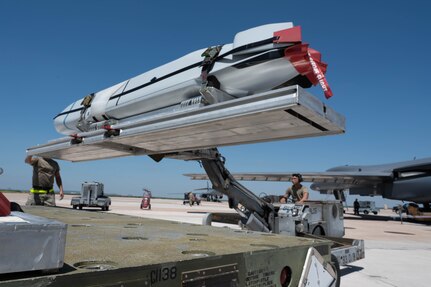 A U.S. Airman operates an MHU-83 lift truck to transfer a Joint Air-to-Surface Standoff Missile off a transport trailer during the Death Strike: Trident Fury exercise at Dyess Air Force Base, Texas, June 23, 2026. The multi-day munitions production exercise focused on strengthening interoperability and proving the joint force's ability to rapidly scale operations in a simulated combat environment. (U.S. Air Force photo by Airman 1st Class William Neal)
