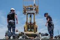 Royal Australian Air Force personnel load munitions onto a trailer with assistance from a forklift during the Death Strike: Trident Fury exercise at Dyess Air Force Base, Texas, June 23, 2026. The joint munitions exercise focused on validating rapid combat employment techniques in an austere environment. (U.S. Air Force photo by Airman 1st Class William Neal)