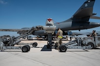 U.S. Airmen transfer a Joint Air-to-Surface Standoff Missile between two MHU-83 lift trucks during a Multi-Role Pylon Load operation as part of the Death Strike: Trident Fury exercise at Dyess Air Force Base, Texas, June 23, 2026. Death Strike is a multi-day munitions production exercise focused on strengthening joint interoperability and proving the joint force's ability to rapidly scale operations in a simulated combat environment (U.S. Air Force photo by Airman 1st Class William Neal)