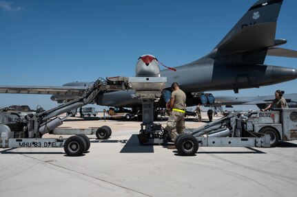 U.S. Airmen transfer a Joint Air-to-Surface Standoff Missile between two MHU-83 lift trucks during a Multi-Role Pylon Load operation as part of the Death Strike: Trident Fury exercise at Dyess Air Force Base, Texas, June 23, 2026. Death Strike is a multi-day munitions production exercise focused on strengthening joint interoperability and proving the joint force's ability to rapidly scale operations in a simulated combat environment (U.S. Air Force photo by Airman 1st Class William Neal)