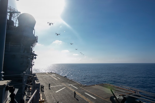 MV-22 Ospreys, attached to Marine Medium Tiltrotor Squadron (VMM) 265, conduct a flyover of forward-deployed America-class amphibious assault ship USS Tripoli (LHA 7), July 21, 2026. Tripoli is currently underway conducting routine operations in the U.S. 7th Fleet area of operations. U.S. 7th Fleet, the U.S. Navy’s largest forward-deployed numbered fleet, routinely interacts and operates with allies and partners in preserving a free and open Indo-Pacific. (U.S. Navy photo by Mass Communication Specialist Seaman Reese Mitchell Taylor)
