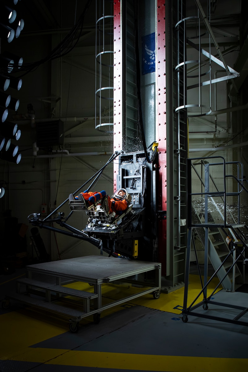 A U.S. Air Force volunteer tests the next replica of a space suit and seat for the Orion spacecraft in the vertical deceleration tower at Wright-Patterson Air Force Base, Ohio, Nov. 3, 2023. The Air Force Research Laboratory’s 711th Human Performance Wing sought active-duty military volunteers for an August 2026 collaborative study with NASA to evaluate the impact forces astronauts will face during future lunar landings. (U.S. Air Force photo / Richard Eldridge)