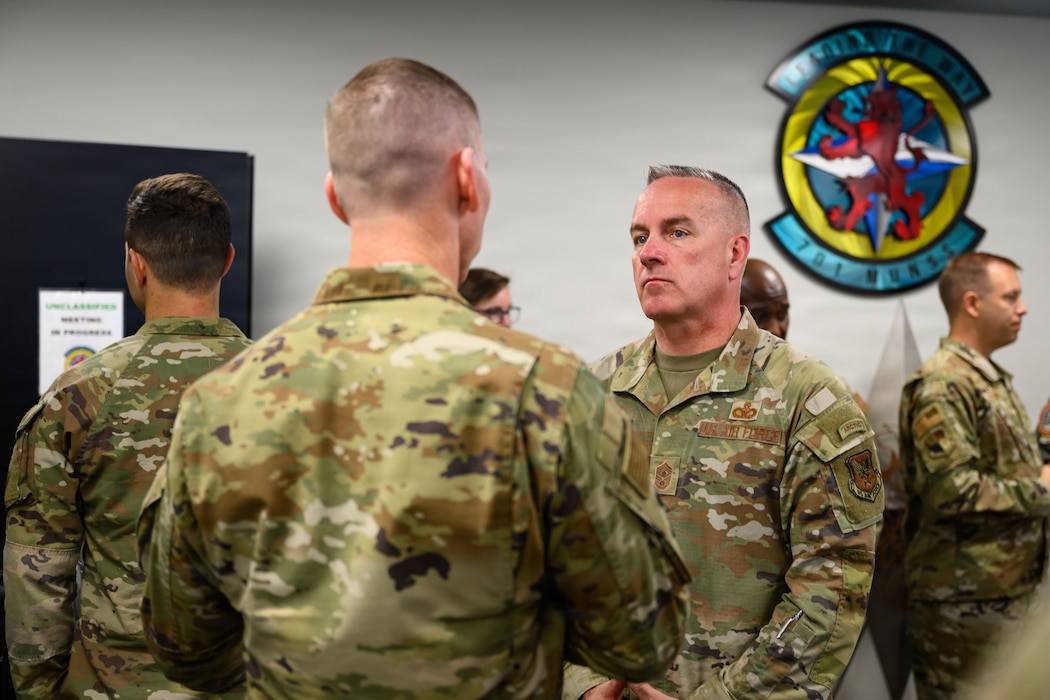 Two U.S. Air Force Airmen speak with each other.