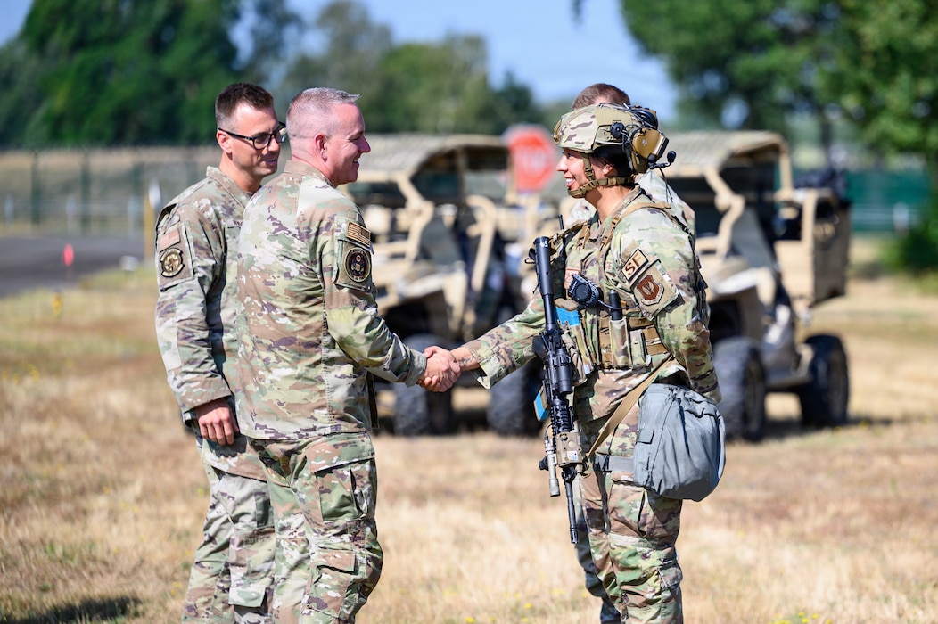 Two U.S. Air Force Airmen shake hands.