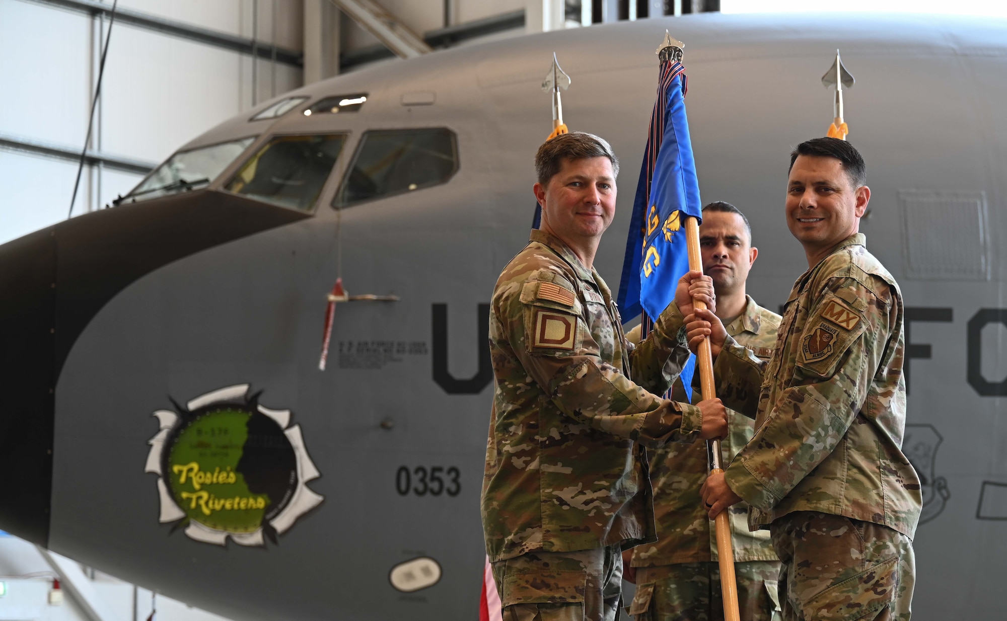 U.S. Air Force Col. Steven Byrum, left, 100th Air Refueling Wing commander, hands a guidon to Col. Christopher Dupuis, 100th Maintenance Group commander, during a change of command ceremony at RAF Mildenhall, England, July 10, 2026. Dupuis’ previous role was chief of staff and chief, commanders action group, Jeanna M. Holm Center for Officer Accessions and Citizen Development, Maxwell Air Force Base, Ala. (U.S. Air Force photo by Karen Abeyasekere)