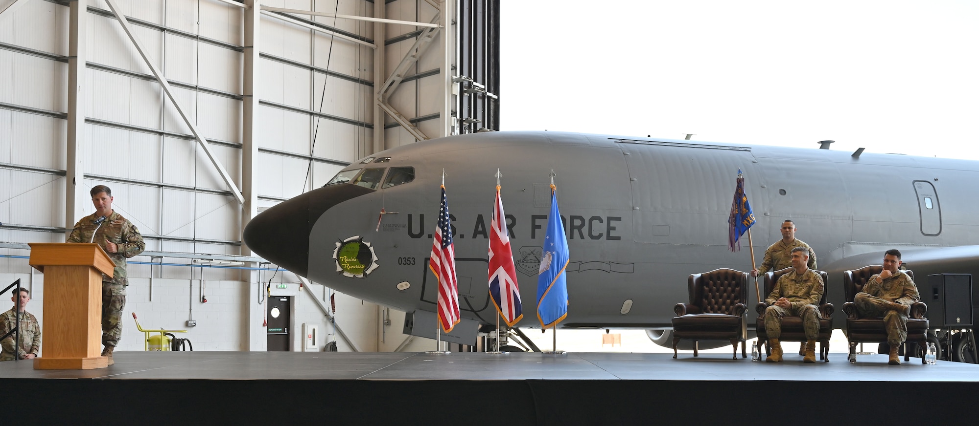 U.S. Air Force Col. Steven Byrum, left, 100th Air Refueling Wing commander, speaks about the accomplishments of Col. Aaron Rivers, center, departing 100th Maintenance Group commander, and welcomes new 100th MXG commander, Col. Christopher Dupuis during a change of command ceremony at RAF Mildenhall, England, July 10, 2026. Rivers headed to Hill Air Force Base, Utah, for his new role as the Ogden Air Logistics Complex deputy commander. (U.S. Air Force photo by Karen Abeyasekere)
