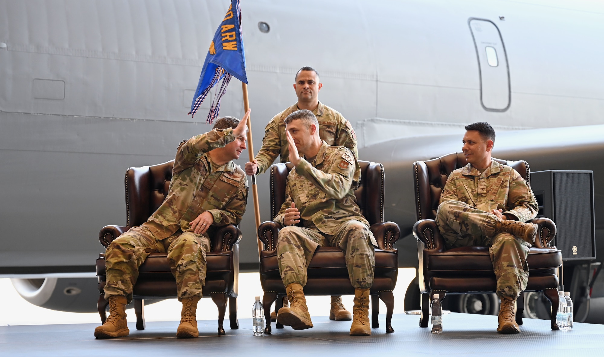 U.S. Air Force Col. Steven Byrum, left, 100th Air Refueling Wing commander, high-fives Col. Aaron Rivers, center, 100th Maintenance Group commander, during a change of command ceremony at RAF Mildenhall, England, July 10, 2026. Rivers headed to Hill Air Force Base, Utah, for his new role as the Ogden Air Logistics Complex deputy commander. (U.S. Air Force photo by Karen Abeyasekere)