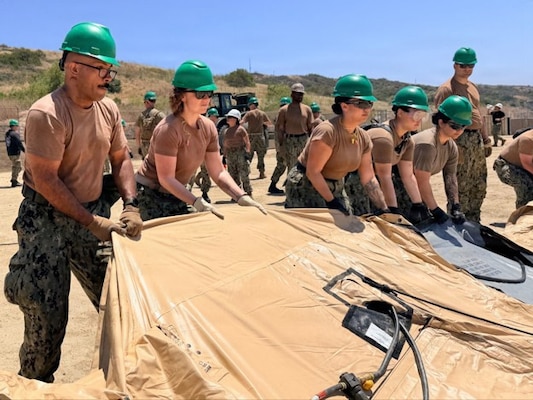 U.S. Navy Sailors assigned to Expeditionary Medical Facility (EMF) Bethesda erect a tactical shelter during a field training exercise at Naval Expeditionary Medicine Warfighter Development Center (NEMWDC) May 10-21, 2026. Trainees practiced the essential construction and infrastructure maintenance skills required to rapidly deploy, establish, and sustain a fully functional medical footprint within austere environments. (U.S. Navy photo by Petty Officer 2nd Class Leandra Mojica)