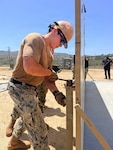 Builder 3rd Class Brandon Llanto, assigned to Naval Mobile Construction Battalion (NMCB) 133, expands an International Organization for Standardization (ISO) container during Expeditionary Medical Facility (EMF) Bethesda training at Camp Pendleton, California, May 11, 2026. The EMF training, conducted by Naval Expeditionary Medicine Warfighter Development Center (NEMWDC), employed Seabees support to construct and prepare expeditionary medical infrastructure, enhancing the EMF’s ability to provide scalable medical care in an austere environment. (U.S. Navy photo by Petty Officer 2nd Class Leandra Mojica)