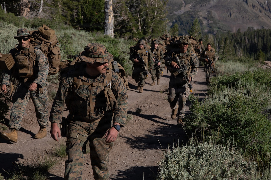 U.S. Marines with Headquarters and Service Company, 3rd Battalion, 25th Marine Regiment, 4th Marine Division, hike during Mountain Training Exercise (MTX) 26-3 at Marine Corps Mountain Warfare Training Center, Bridgeport, California, July 15, 2026. MTX is an annual two-week training evolution that is designed to strengthen unit cohesion and prepare the battalion for rapid mobilization in support of future global operations. (U.S. Marine Corps photo by Cpl. Orion Stpierre)