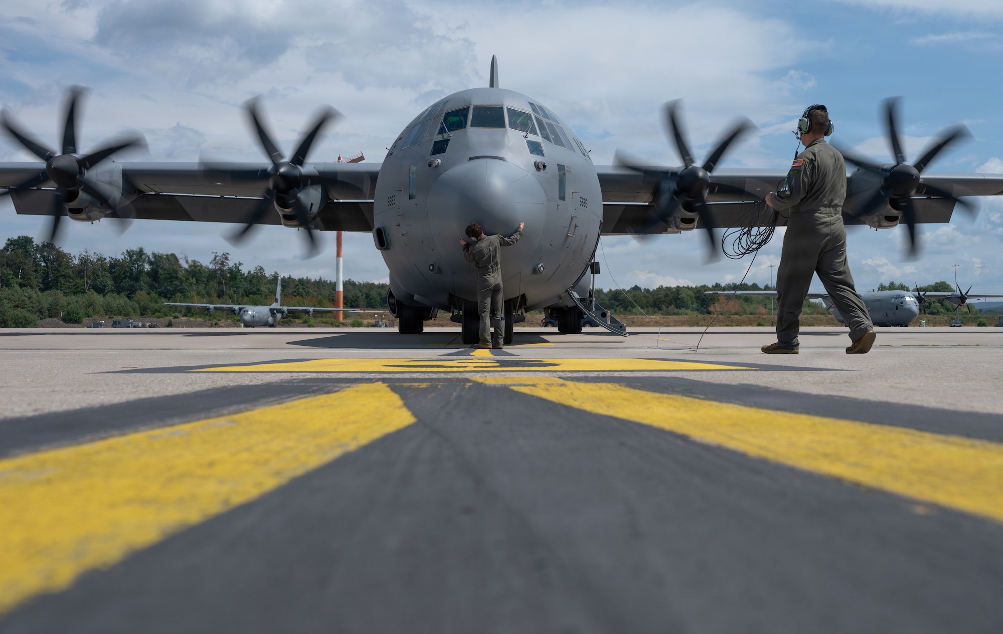Airmen conduct pre flight inspection of aircraft