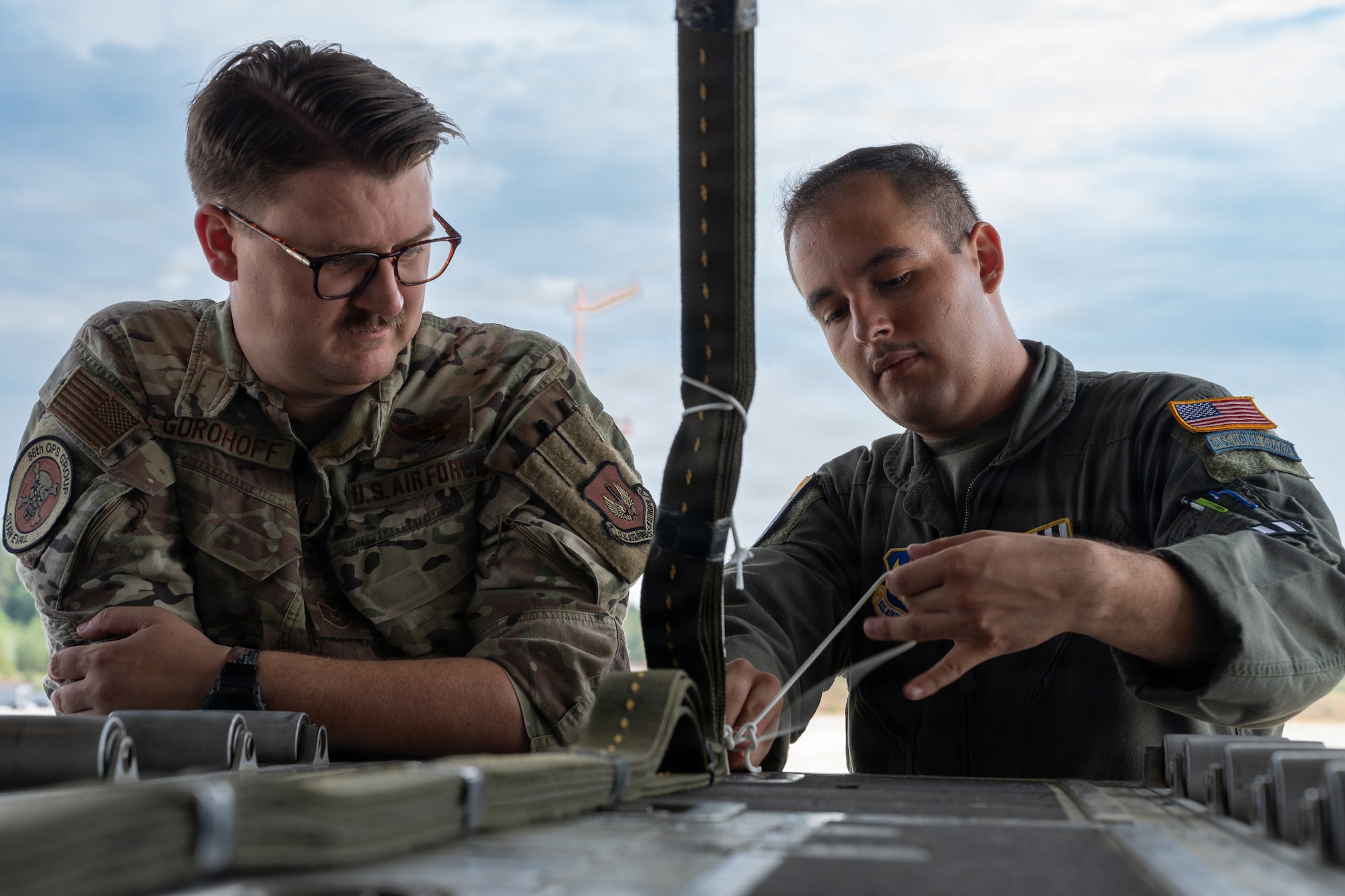 Airman ties down extraction parachute