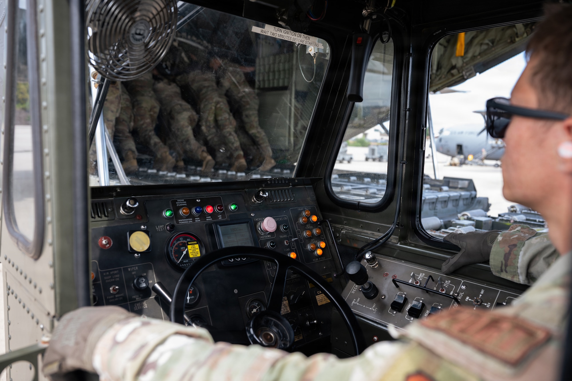 Airmen load cargo into aircraft