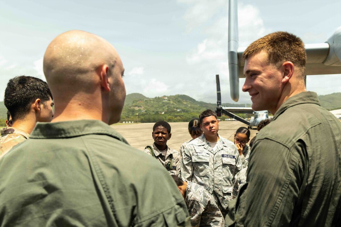 U.S. Marines, with Marine Medium Tiltrotor Squadron (VMM) 365 (Reinforced), Littoral Combat Force-24, explain the components on a MV-22B Osprey to Cadets, with the Civil Air Patrol, Puerto Rico Wing, during a communication relations event on Jose Aponte De La Torre Airport in Ceiba, Puerto Rico, July 13, 2026. Events like these reinforce our commitment to community engagement, bridging the gap between current service members and the people we serve. (U.S. Marine Corps photo)