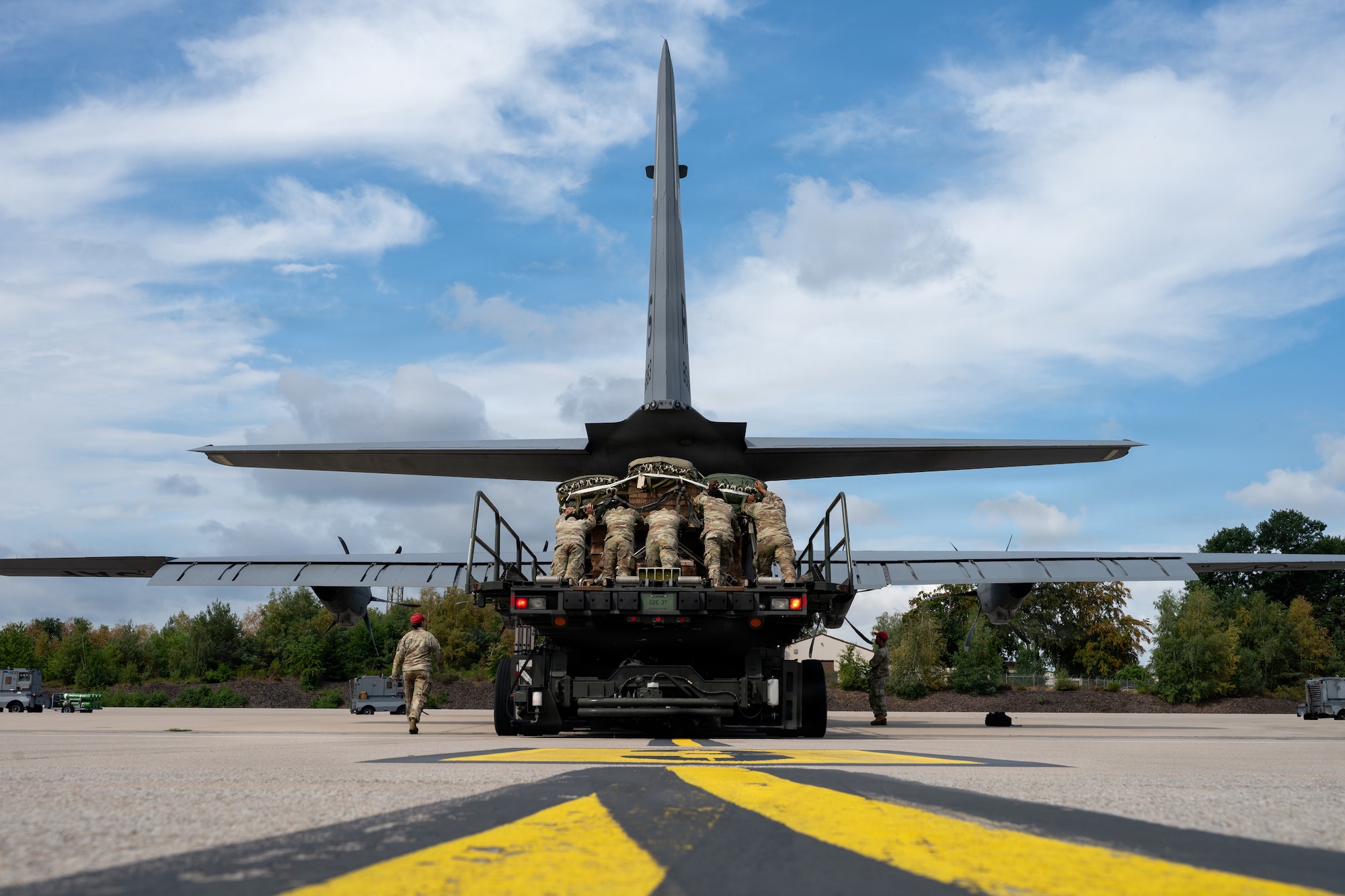 Airmen push cargo into aircraft