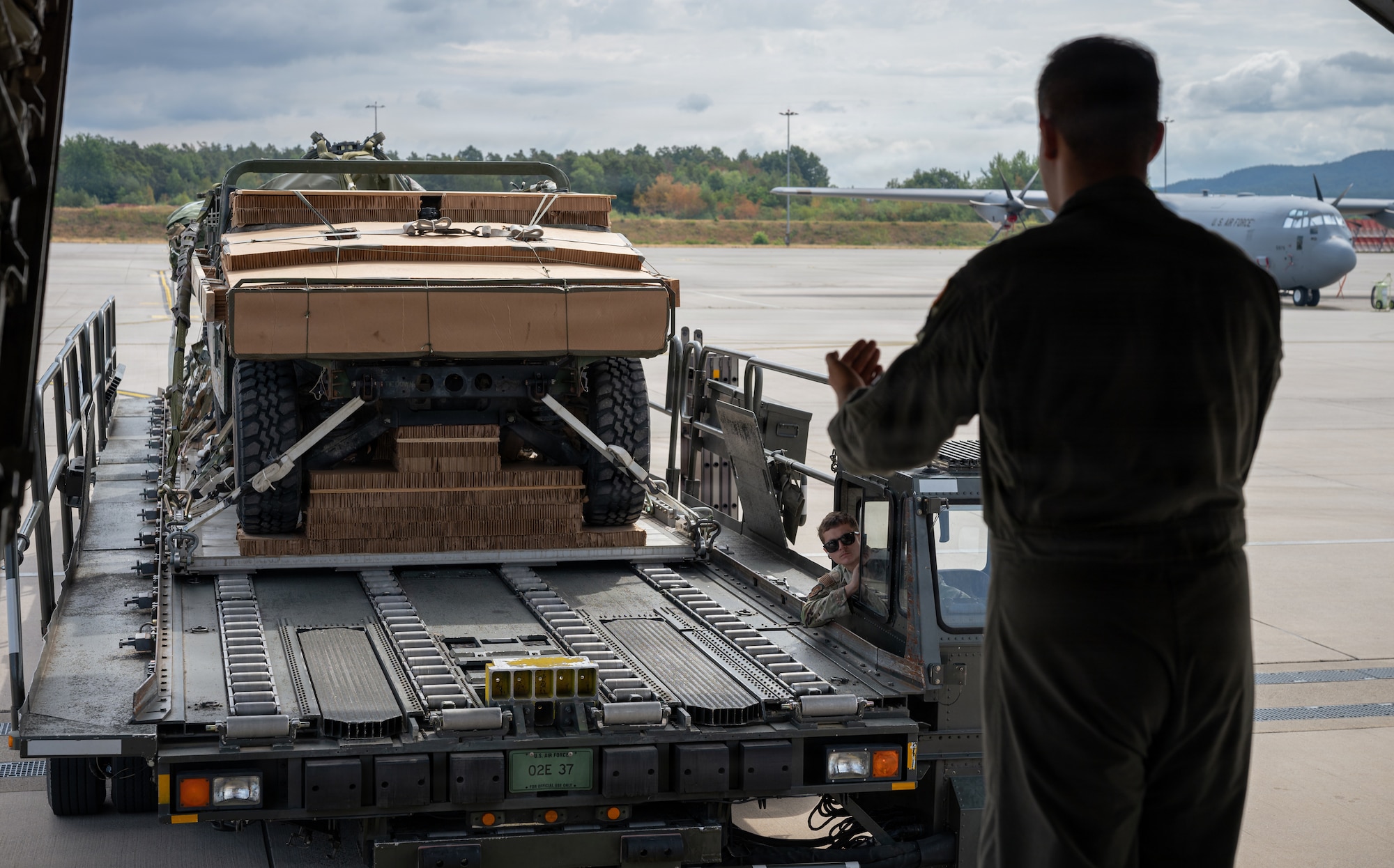 Airman Marshalls cargo into aircraft