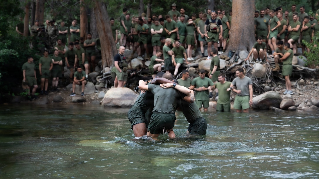 U.S. Marines with 3rd Battalion, 25th Marine Regiment, 4th Marine Division, cross a river during Mountain Training Exercise (MTX) 26-3 at Marine Corps Mountain Warfare Training Center, Bridgeport, California, July 14, 2026. MTX is an annual two-week training evolution that is designed to strengthen unit cohesion and prepare the battalion for rapid mobilization in support of future global operations. (U.S. Marine Corps photo by Cpl. Orion Stpierre)