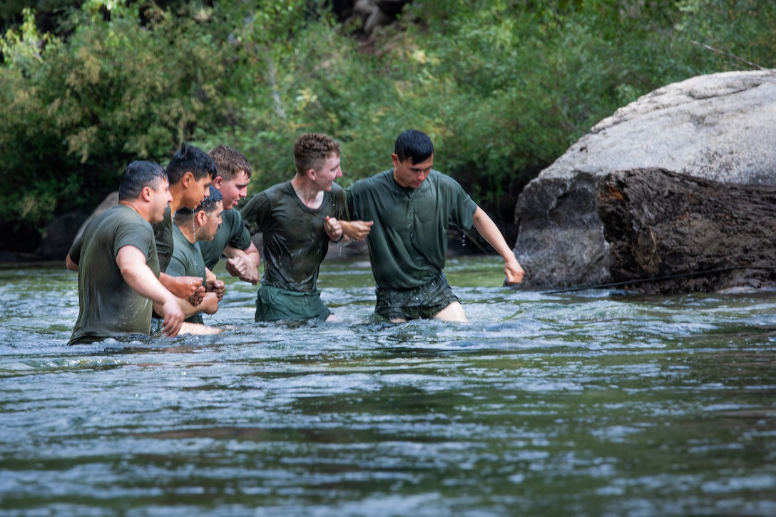 U.S. Marines with 3rd Battalion, 25th Marine Regiment, 4th Marine Division, cross a river during Mountain Training Exercise (MTX) 26-3 at Marine Corps Mountain Warfare Training Center, Bridgeport, California, July 14, 2026. MTX is an annual two-week training evolution that is designed to strengthen unit cohesion and prepare the battalion for rapid mobilization in support of future global operations. (U.S. Marine Corps photo by Cpl. Orion Stpierre)