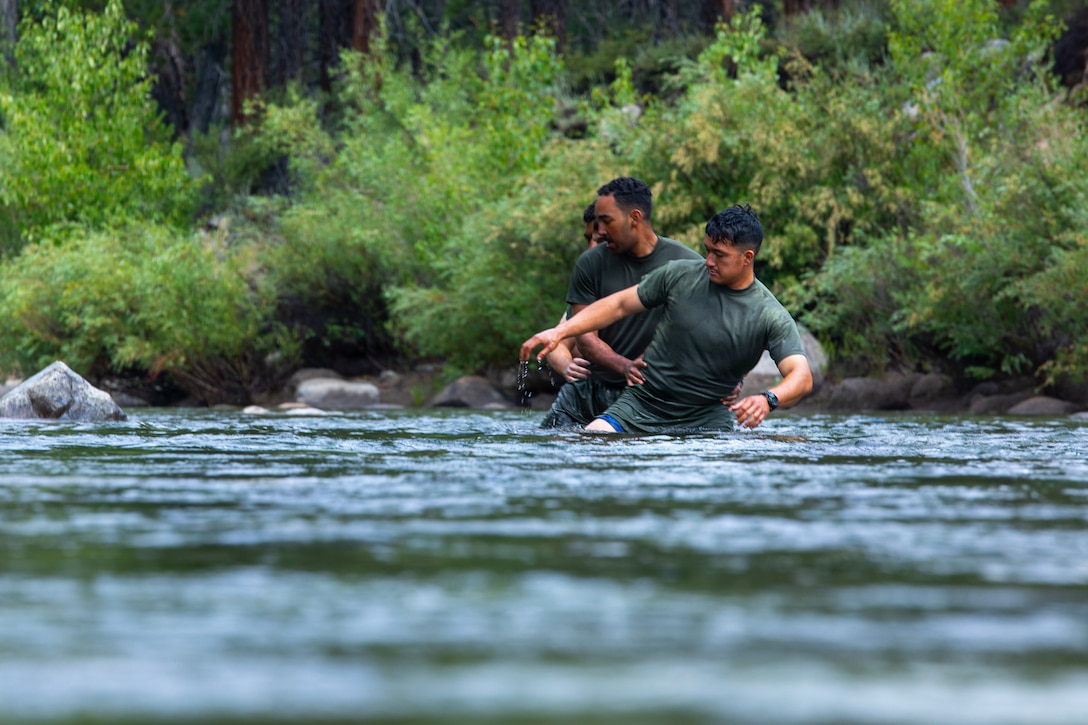 U.S. Marines with 3rd Battalion, 25th Marine Regiment, 4th Marine Division, cross a river during Mountain Training Exercise (MTX) 26-3 at Marine Corps Mountain Warfare Training Center, Bridgeport, California, July 14, 2026. MTX is an annual two-week training evolution that is designed to strengthen unit cohesion and prepare the battalion for rapid mobilization in support of future global operations. (U.S. Marine Corps photo by Cpl. Orion Stpierre)