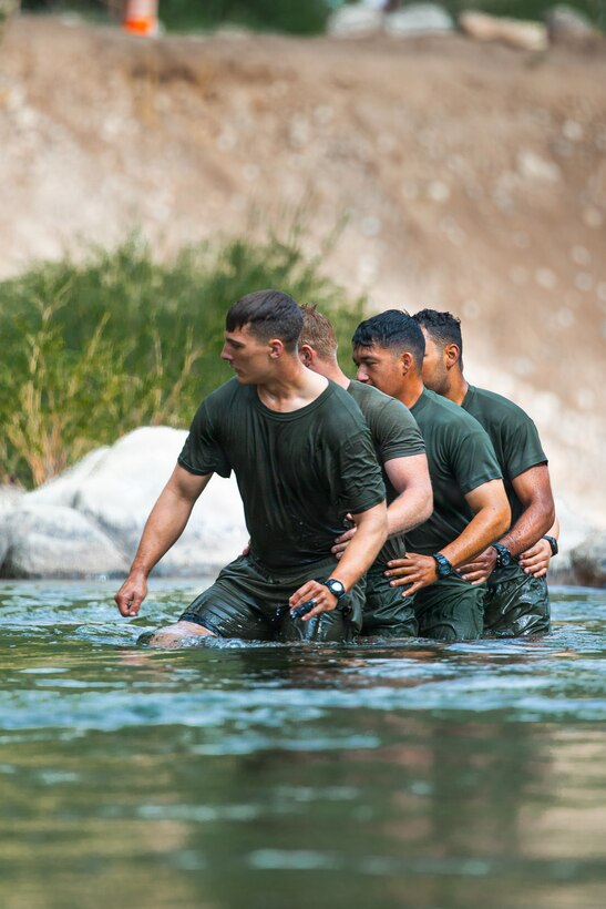 U.S. Marines with 3rd Battalion, 25th Marine Regiment, 4th Marine Division, cross a river during Mountain Training Exercise (MTX) 26-3 at Marine Corps Mountain Warfare Training Center, Bridgeport, California, July 14, 2026. MTX is an annual two-week training evolution that is designed to strengthen unit cohesion and prepare the battalion for rapid mobilization in support of future global operations. (U.S. Marine Corps photo by Cpl. Orion Stpierre)